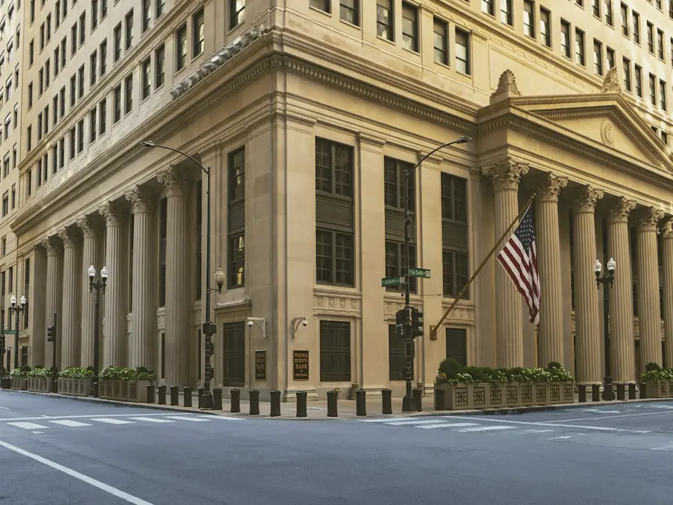 Stone bank building with tall columns on a city corner